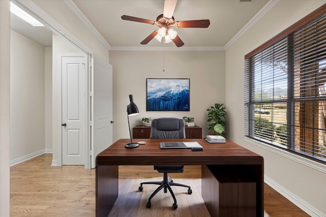 office space featuring ornamental molding, baseboards, and light wood finished floors