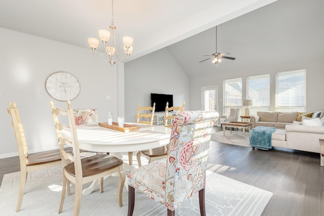 dining space with dark wood-style floors, baseboards, high vaulted ceiling, and ceiling fan with notable chandelier