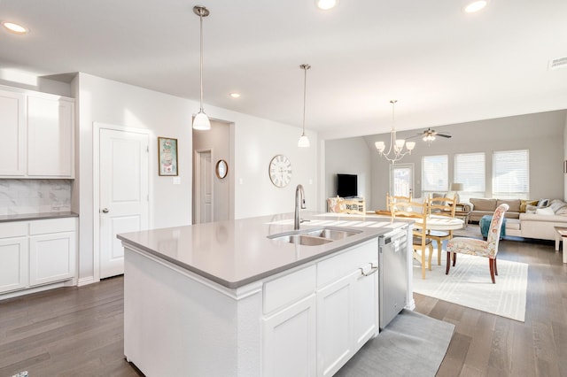 kitchen with a sink, white cabinetry, open floor plan, dishwasher, and an island with sink