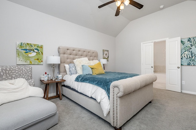 bedroom featuring light carpet, ceiling fan, vaulted ceiling, and ensuite bathroom