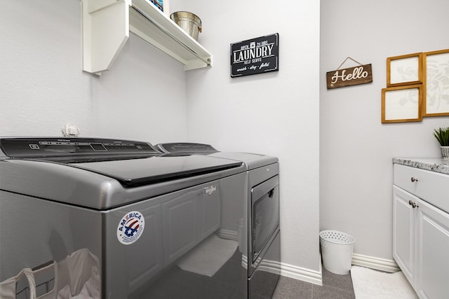 washroom featuring washer and dryer, cabinet space, and baseboards