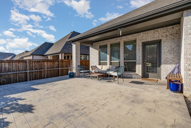 view of patio / terrace featuring an outdoor hangout area and fence