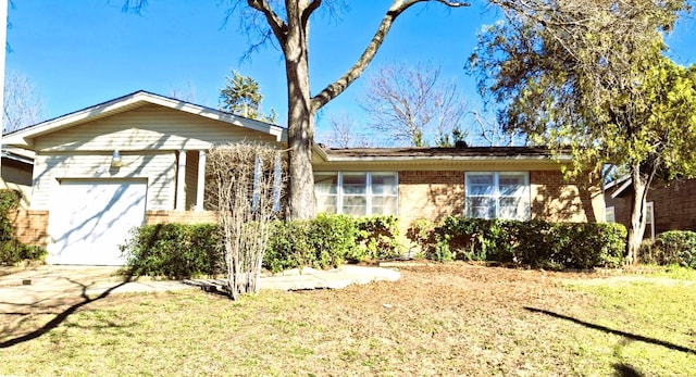 ranch-style house with brick siding, a front lawn, and an attached garage