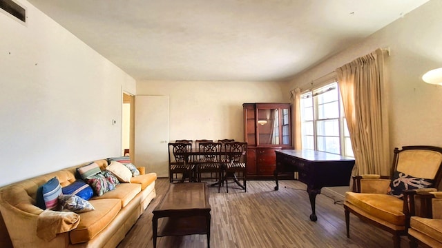 living room with visible vents and wood finished floors