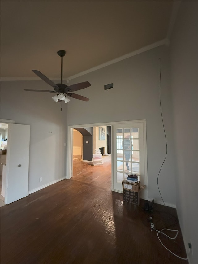 spare room featuring ceiling fan, arched walkways, crown molding, and wood finished floors