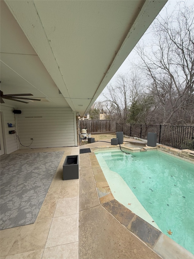 view of pool featuring a patio area, a fenced backyard, ceiling fan, and a fenced in pool