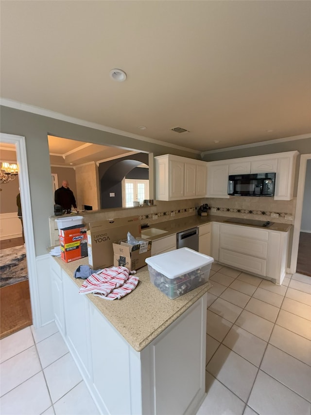 kitchen with light tile patterned floors, a peninsula, white cabinetry, ornamental molding, and black appliances