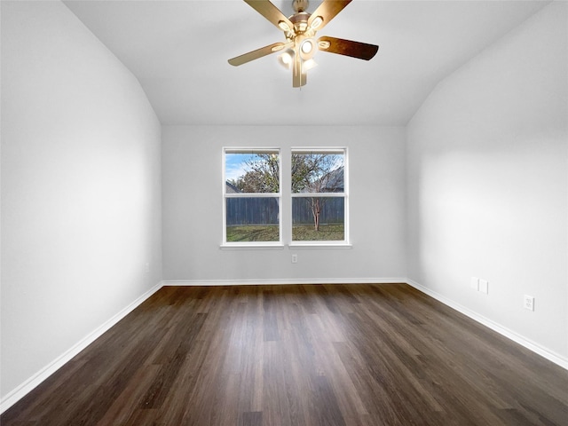 empty room with lofted ceiling, dark wood finished floors, baseboards, and ceiling fan