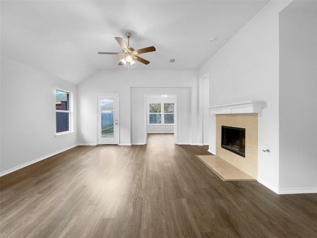 unfurnished living room with a fireplace, visible vents, a ceiling fan, baseboards, and dark wood finished floors