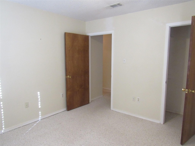 unfurnished room with light carpet, baseboards, and visible vents