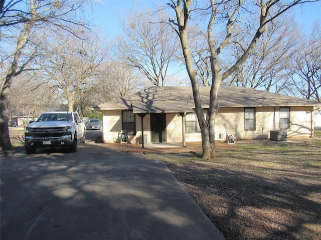 ranch-style home featuring central AC and aphalt driveway