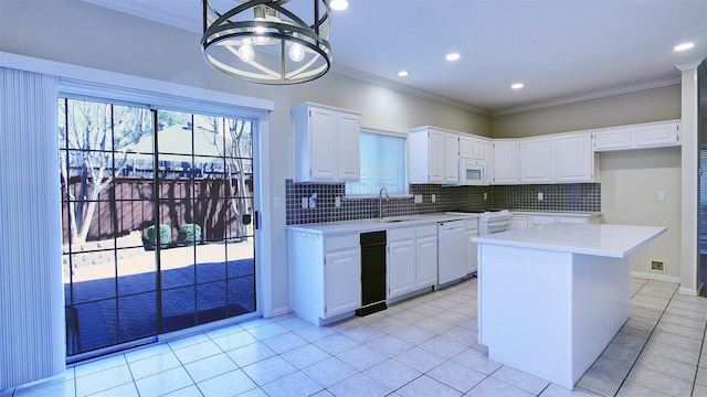 kitchen with white appliances, light countertops, and ornamental molding