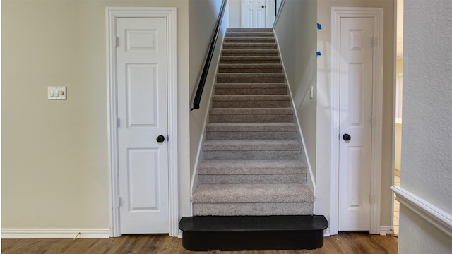 stairs featuring baseboards and wood finished floors