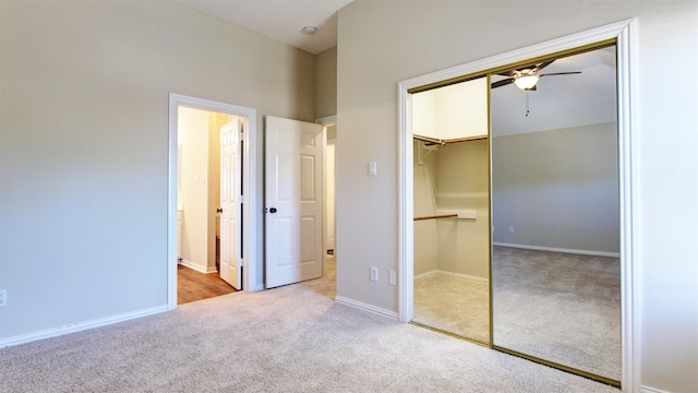 unfurnished bedroom with connected bathroom, baseboards, a closet, and light colored carpet