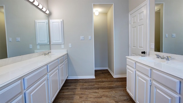 full bathroom with baseboards, wood finished floors, and vanity