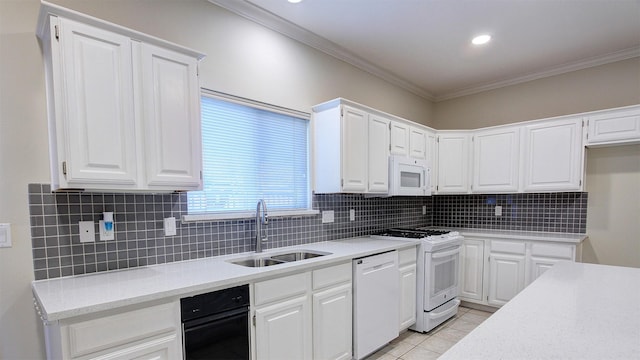 kitchen featuring light countertops, white appliances, a sink, and white cabinetry