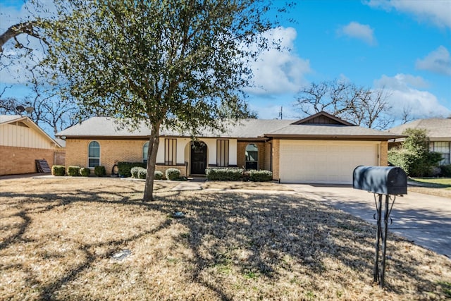 ranch-style house with an attached garage, concrete driveway, and brick siding