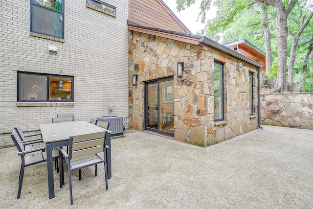 view of patio featuring central AC unit and outdoor dining space