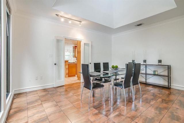 dining area with tile patterned floors, baseboards, visible vents, and ornamental molding