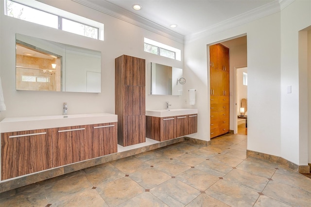 bathroom featuring two vanities, ornamental molding, a sink, a shower stall, and baseboards