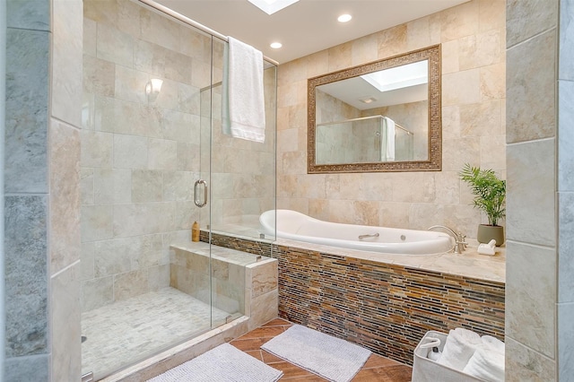 bathroom with a bath, a shower stall, tile walls, and recessed lighting