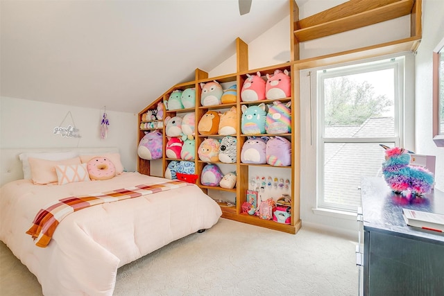 bedroom featuring lofted ceiling, carpet, and a ceiling fan