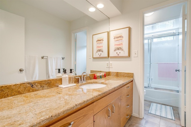 bathroom with tile patterned flooring, shower / bath combination with glass door, vanity, and recessed lighting