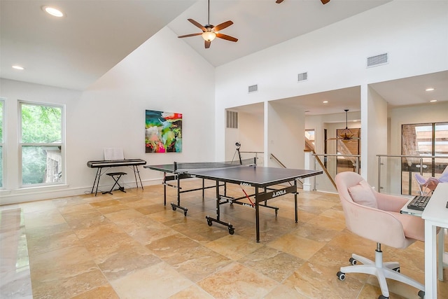 rec room featuring high vaulted ceiling, ceiling fan, and visible vents