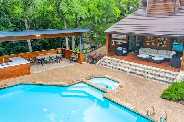 outdoor pool with outdoor dining space, an outdoor living space, and an in ground hot tub