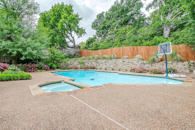 view of pool with an in ground hot tub, a patio area, a fenced backyard, and a fenced in pool