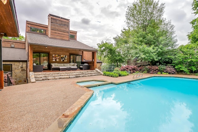 pool with a patio, fence, an outdoor living space, and an in ground hot tub