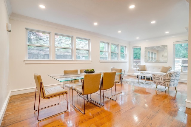 dining space with recessed lighting, crown molding, light wood-style flooring, and baseboards