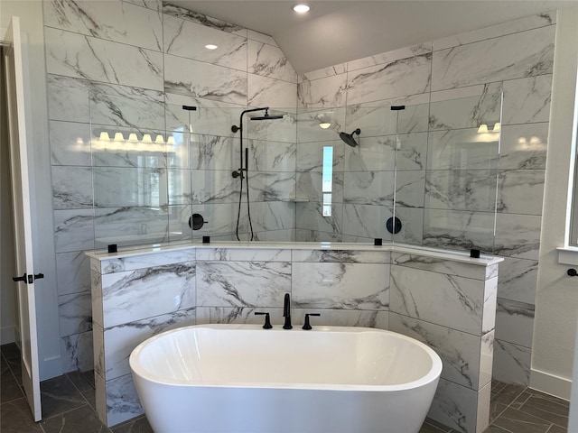 full bathroom featuring marble finish floor, a walk in shower, and a freestanding bath