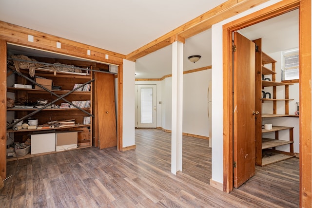 interior space with baseboards and wood finished floors