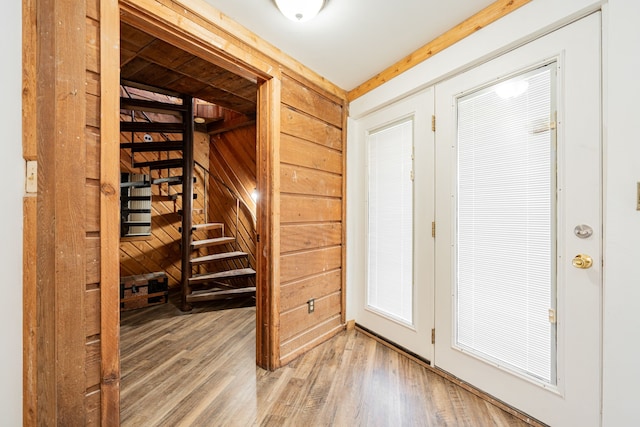 entryway with a sauna, wood finished floors, and wooden walls