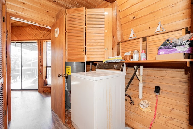 laundry room featuring wood walls, wood ceiling, laundry area, and washer / clothes dryer