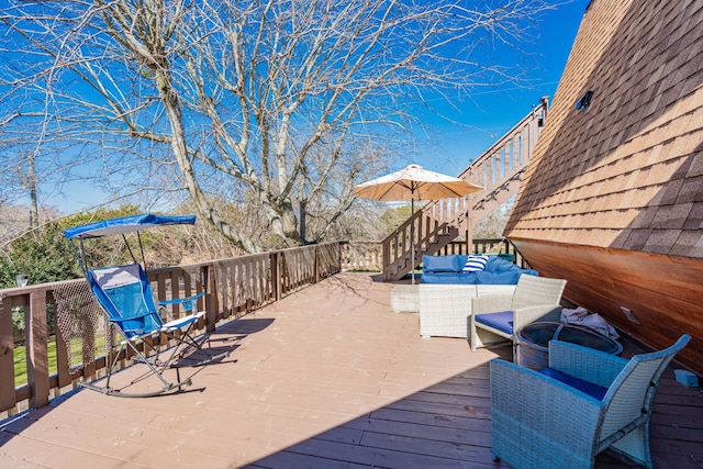 wooden terrace featuring stairs and an outdoor hangout area