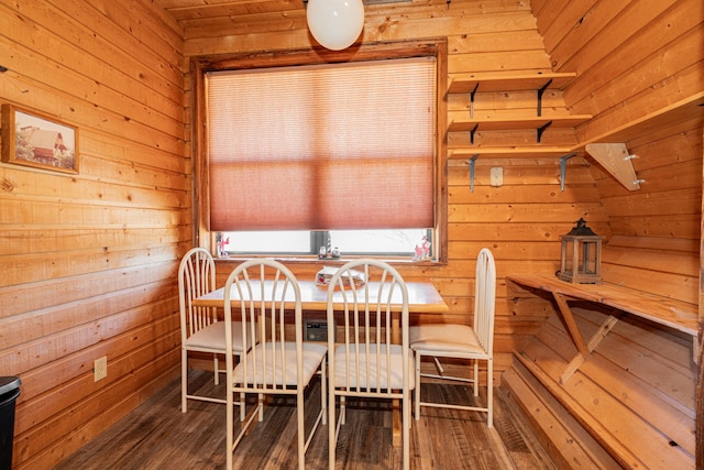 dining area featuring wood walls and dark wood-style floors