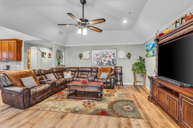 living room featuring arched walkways, visible vents, a ceiling fan, vaulted ceiling, and light wood-type flooring