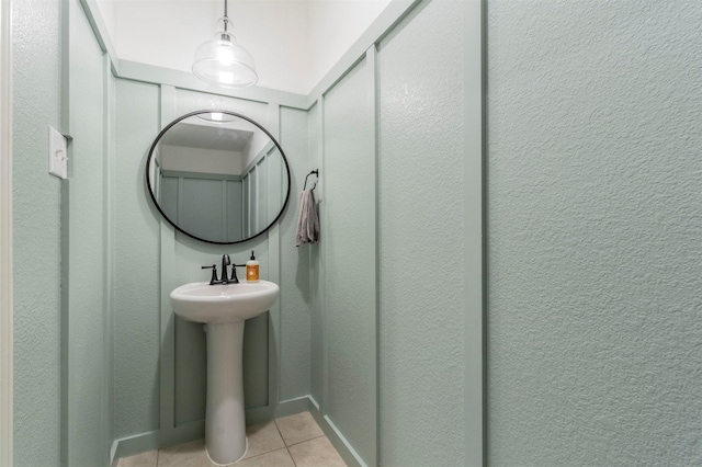 bathroom featuring tile patterned flooring and a sink