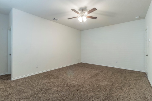 empty room featuring baseboards, carpet flooring, visible vents, and a ceiling fan