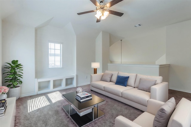 living area featuring baseboards, visible vents, vaulted ceiling, and carpet flooring