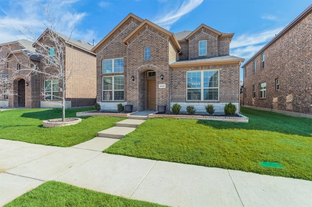 view of front of home with brick siding and a front lawn