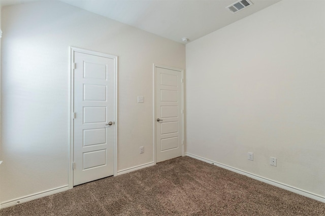 unfurnished bedroom featuring carpet flooring, visible vents, and baseboards