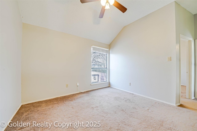 empty room with vaulted ceiling, light carpet, a ceiling fan, and baseboards