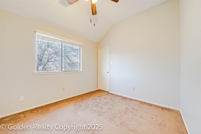 unfurnished room with lofted ceiling, light carpet, a ceiling fan, and baseboards