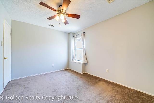 carpeted empty room featuring a ceiling fan, baseboards, visible vents, and a textured ceiling