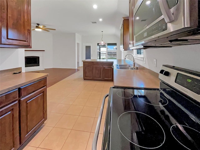 kitchen featuring light tile patterned floors, visible vents, appliances with stainless steel finishes, and a sink