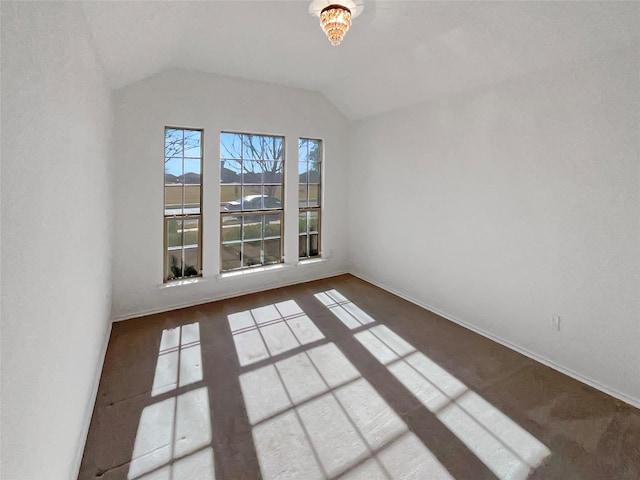 spare room with lofted ceiling and baseboards