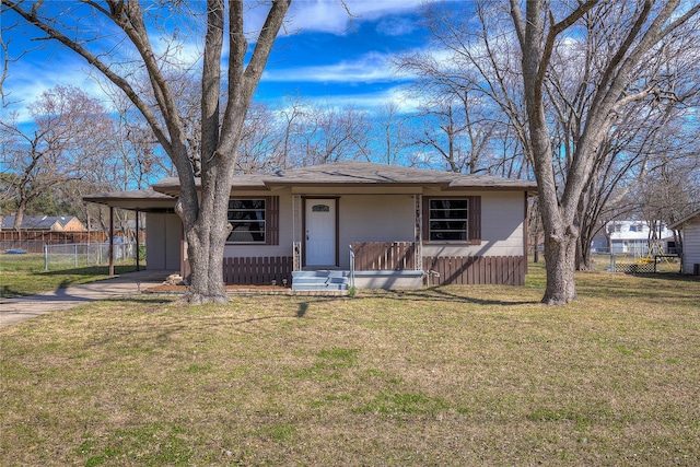 view of front of house with a carport, concrete driveway, fence, and a front lawn